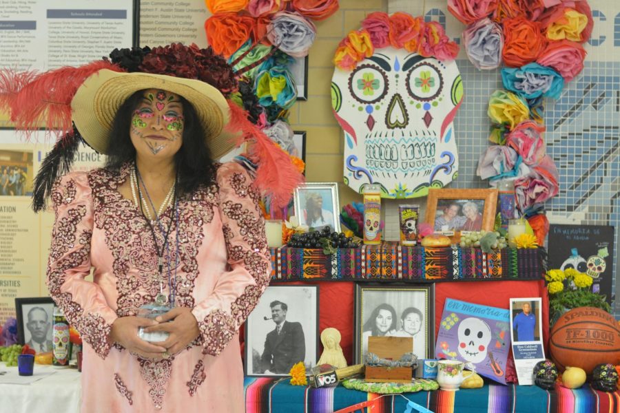 REVISITING VIERNES: Spanish teachers celebrated Day of the Dead on campus in a couple of ways on Friday. Señora Gun came dressed for the occasion and stopped by 134 for a MacJournalism portrait session by the Day of the Dead altar in the main hallway. Gun offered "a big shout out to Mrs. Rios Tiessen and Mr. Seckar Martinez and the art students for the beautiful altar!" Photo by Alex Dowd.