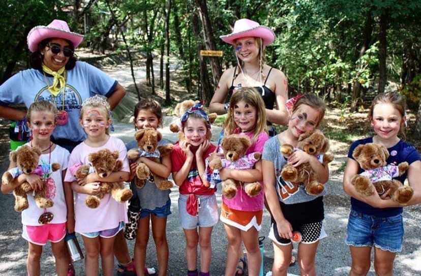 Catie+Mendivil+poses+with+a+fellow+counselor+and+her+troupe+of+campers+at+a+girls+summer+camp+in+Wimberley.+Mendivil+enjoys+spending+her+summers+with+kids.+%E2%80%9CI+never+was+a+person+who+thought+I%E2%80%99d+love+spending+time+with+kids%2C+but+I+think+it%E2%80%99s+fun%2C%E2%80%9D+Mendivil+confesses.+%E2%80%9CI+would+encourage+people+who+want+to+like+babysit%2C+or+get+involved+with+kids%2C+to+do+it.+It%E2%80%99s+really+fun%2C+and+kids+are+hilarious.%E2%80%9D+Photo+courtesy+of+Mendivil.