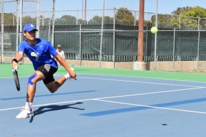 Sophomore Micheal Alverson competes at the 2019 District tennis meet on Oct. 1. Photo by Esme Moreno-Bernacki. 