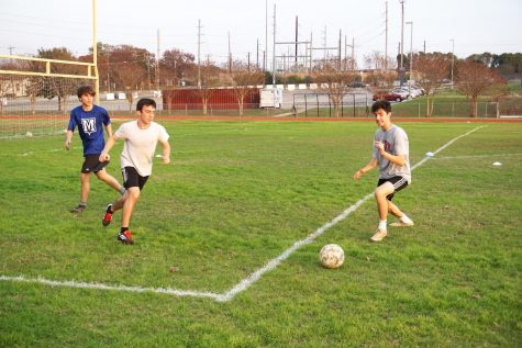 Senior Jimmy Walker makes a break for the goal at soccer tryouts on Dec. 9. Photo by Thomas Melina Raab. 