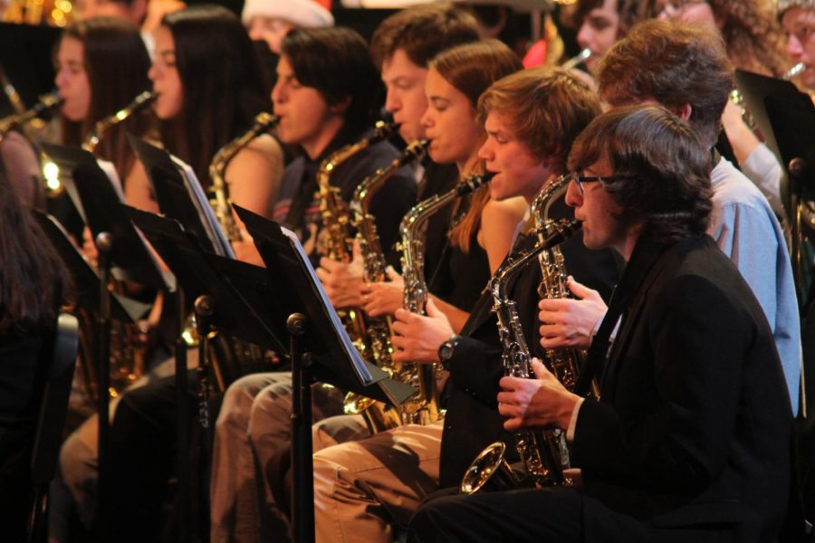 JINGLE BELL JAZZ: As finals and winter break rapidly approach, band celebrated the festive season with their annual holiday concert on December 9. Many band members even dressed up in red and green to add to the holiday spirit. The evening started off with a selection of songs from jazz band featuring their vocalist Maryanna Tollemache. After that, the percussion section performed a few pieces they’ve been working on, preparing for their upcoming performance at the Midwest Clinic in Chicago. “It was crazy to see how much they have on their plate,” clarinetist Isobel Buffum-Robbins said, “And [they] still put out such a good product.” Finally, the full McCallum Band went on stage with five pieces: Sleigh Ride, Polar Express, Still Still Still, Three Moods of Hanukkah, and Christmas Festival. “I’ve always had fun during winter concerts but this year was different,” said junior Kyle Davis. “The audience was massive compared to years previous and that helped build a lot of people’s confidence. To know that every person out there is excited to hear you play just makes you feel so happy and more in spirit.” Photo by Bela Tapperson.