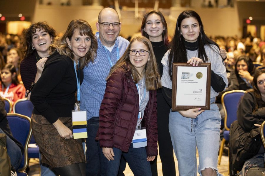 Junior Shield visuals editor and social media coordinator Bella Russo, NSPA board member and ILPC director Jeanne Acton, adviser Dave Winter and seniors, Shield co-editor in chief Kristen Tibbetts, Knight editor in chief Mira MacLaurin and Shield copy editor Alex Dowd, pose with the NSPA Best of Use of Social Media Promotion, one of two first place national awards the MacJournalism social media accounts earned at the DC convention. The other first place award was for best reporting. Photo by Mitchell Franz/NSPA.