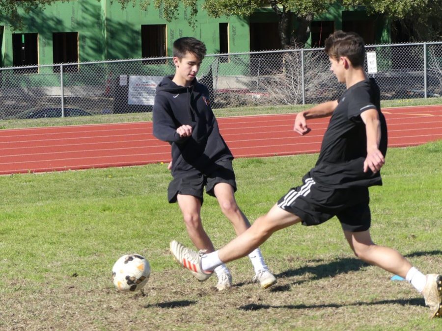 FRESH MEAT (Dec. 17): Sophomore Cooper DeMont blocks a kick made by freshman Noah Dainton. For both players, this is their first year on varsity. For most, joining a team where most players already know each other can be scary. But for Dainton, it was a little bit different. “It’s been great. I already feel like just another guy on the team.” DeMont and Dainton will make their varsity debut on Thursday against Anderson.