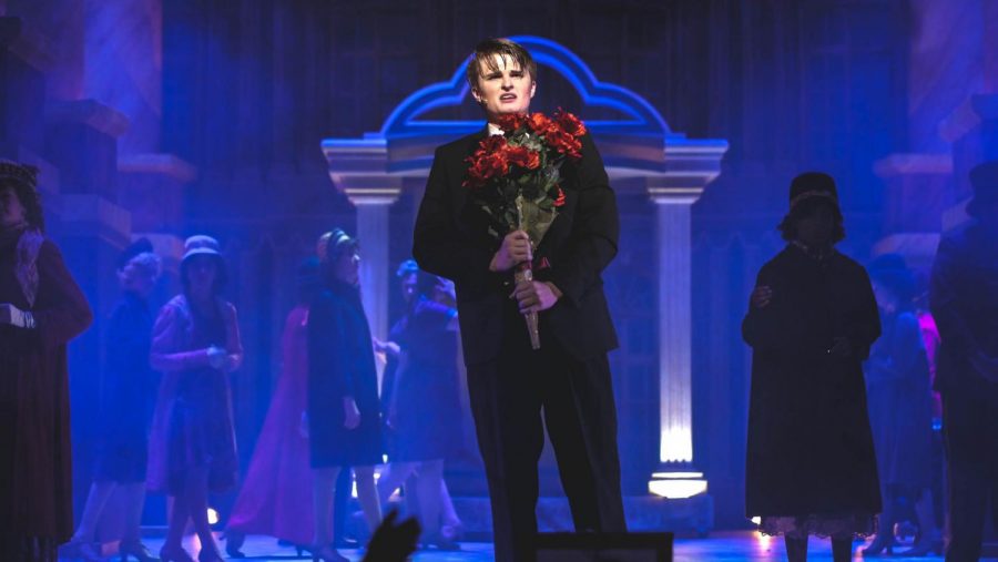 TRAIN TO NOWHERE: Junior Corin Vandenburg, as Baron Felix Von Gaigern, performs the heartbreaking love song Elizaveta at the Station. Behind him, the ensemble moves in slow motion to help paint the picture of a busy train station. “During this scene, the Baron is reliving his life and realizing how much he regrets not doing, ” said Vandenburg. “It was a lot of fun to think about what it would be like in that situation.” Photo by Angus Sewell McCann.