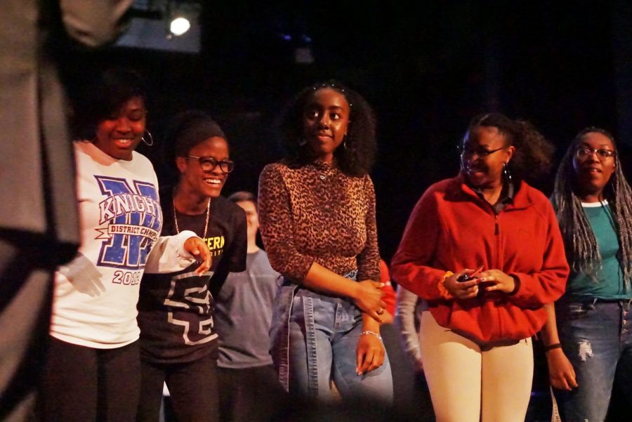 JUST SMART: Seniors Danielle Atwood, Lia Jones, Brooke Miller and Kyla Gibson, and junior Vivian Odoms volunteer to go on stage during Dr. Leonard Moore’s fourth-period talk. Gibson said that being a person of color has impacted her experiences at school “In AP classes the teachers are always like, ‘Oh my God we love you, you’re so smart.’ But there’s always that stereotype of “you’re smart for a black person,” Gibson explained. “I just want to be smart for being smart.” Photo by Regan Sims.