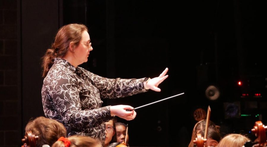 CONDUCTOR OF THIS TRAIN: Assistant orchestra director Erika Elder conducts the non-varsity full orchestra before its Pre-UIL concert, on Tuesday Feb. 11. The performance helped the orchestra stay on track with its weekly Tuesday rehearsals. “I thought we did pretty well overall, Elder said. Of course there was stuff that needed improvement, but I was happy with the performance. I think we will do great at UIL.” Photo by Steven Anzures.
