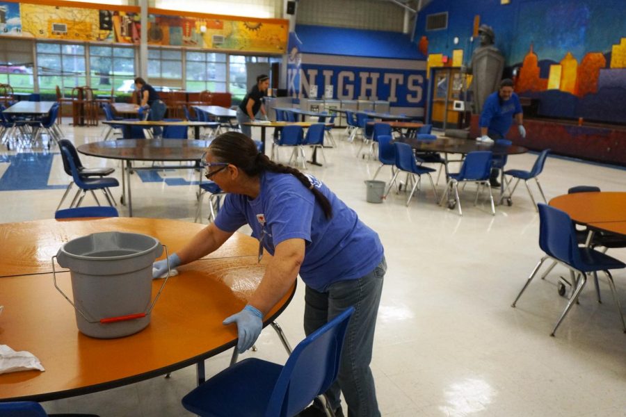 GUARDIANS+OF+OUR+GALAXY%3A+The+custodial+staff+begins+a+deep+clean+of+the+Mac+campus+on+Friday+March+13+by+wiping+down+the+tables+in+the+cafeteria.+Originally+the+deep+clean+was+to+take+place+during+spring+break%2C+but+because+of+todays+districtwide+cancellation%2C+administrators+decided+to+start+it+today+instead.+Assistant+principal+Gabe+Reyes+urged+all+teachers+to+make+their+classrooms+ready+for+the+deep+clean+by+10+a.m.+Photo+by+Dave+Winter.