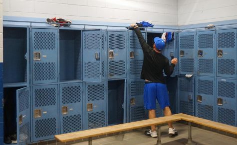 Originally, varsity baseball coach was going to mow the softball field then head to the Leander ISD Tournament with his baseball team, but instead he spent Friday prepping the locker room in the field house for the deep clean originally scheduled for spring break. Photo by Dave Winter.