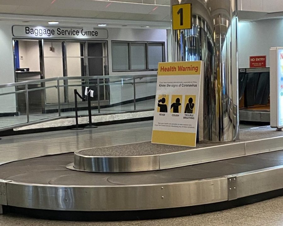 A+sign+at+baggage+claim+at+the+LaGuardia+Airport+in+Queens+illustrates+the+common+symptons+of+coronavirus+so+that+customers+can+be+aware+of+them+while+travelling.+Photo+by+Mia+Terminella.