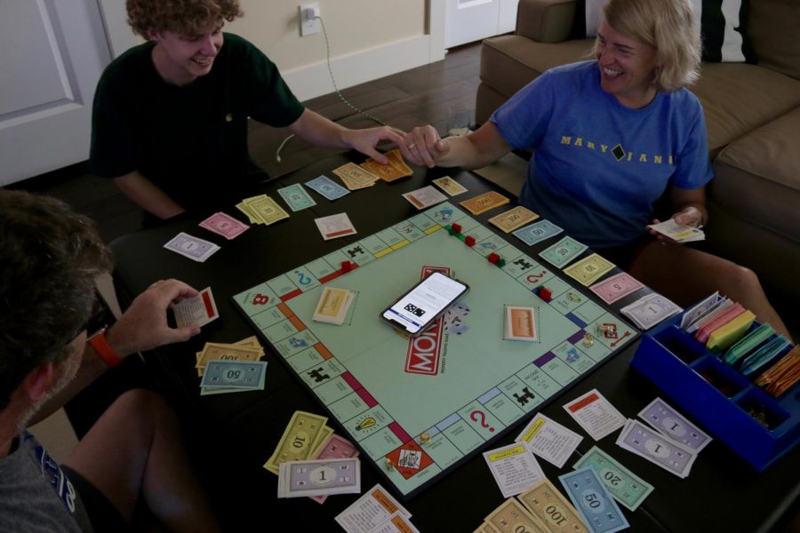 FAMILY GAME NIGHTS: This photo was taken of our family game night just this past week, and this is a perfect example of work and family in our household. Every week on Friday the whole family gets together and plays a game. Without this bonding time, work time would overpower family time. So this time is crucial to balance work and family. Our game night is so that we can put or school or work troubles aside and just enjoy a fun night with the family. They are also so important because all of our busy work lives it is hard to make time for family. Photo by Emmi Anderson.