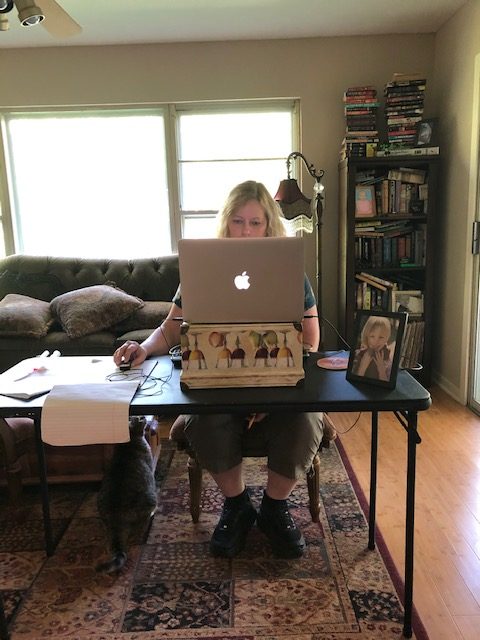 HARD WORKING: On my moms first day to Work she decides to make herself a homemade office, she takes a table we had and the chair and puts it in the other living room, then uses a box as her computer stand to make it eye level to her. Photo by Emily Cormack.