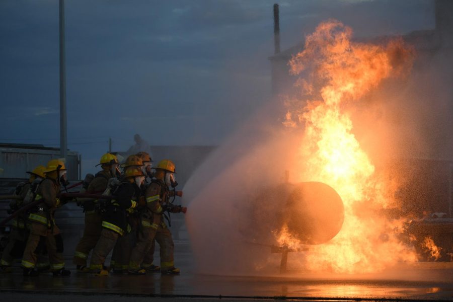 Attacking the fire from the side, the LBJ Fire Academy seniors inch their way closer and closer to the propane tank with the hopes of turning off the gas nozzle feeding the flames during their live fire exercise on Oct. 12. Currently, seven McCallum students are enrolled in the academy, a student sharing program open to all AISD students interested in fire science and emergency medical training. The drills were held at the Austin Fire Academy, where the city of Austin and Austin Community College also train fire fighters.