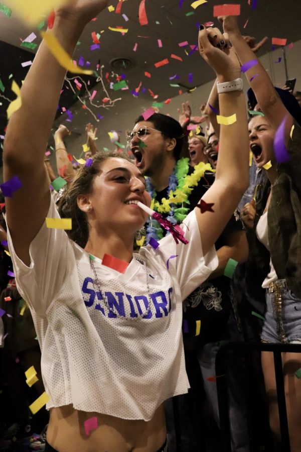 SENIOR BATTLE CRY: Senior Shaine Rozman celebrates with her fellow peers shortly after the seniors won the spirit stick at the Taco Shack pep rally in the big gym. The spirit stick is given to the grade who has the most spirit. The winner is determined by the volume and enthusiasm the grade brings for the battle cry chant that is performed each pep rally. 
