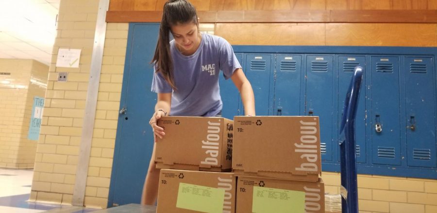Aranza Sanchez unloads boxes of the 2019 yearbook into Room 134 on May 18, 2019. The 2020 edition of the Knight will arrive and be distributed on Aug. 7.