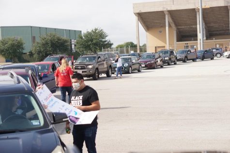 The rally, organized by Education Austin, began at two separate locations at Burger Stadium and Nelson Field, where cars then caravanned to the Southfield headquarters. Photo by Alysa Spiro.