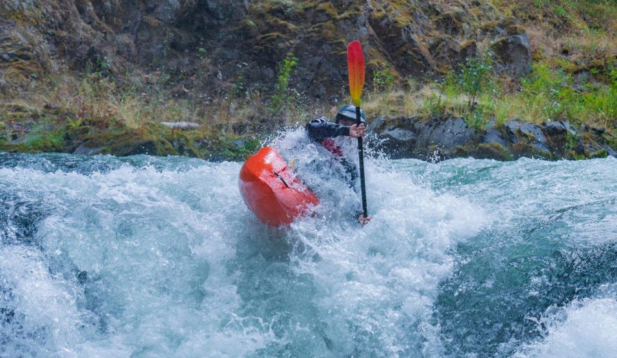 Alex Tita, a junior at the World Class Kayak Academy, paddles down the lower White Salmon River in Banks, Idaho. This is one of our everyday sections, Tita said, I am taking a boof stroke over Steelhead Falls. Photo by Kalob Grady.