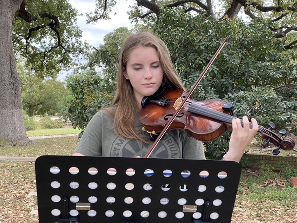 Freshman Ingrid Smith plays at an outdoor concert today organized by her teacher Laura Poyzer. Smith played a solo piece, accompanied by a quartet that included Poyzer and three other people. Smith said that the outdoor concert was Poyzer’s idea because she and her violin students hadn’t seen each other since March and could play music together safely outdoors. Smith was one of 12 Mac orchestra violinists named to the TMEA All-Region 18 orchestra a weekend ago. 

“Making region is like validation for all my hard work,” Smith told MacJournalism. “It was a goal of mine to make region even before I got the music in May, and even though I know region will be different this year, I’m proud of myself for achieving my goal, putting in the work, and seeing myself succeed.”

