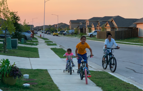 Taking a ride around their neighborhood,  Telvi Altamirano Cancino and her children enjoy their evening family time. Photo courtesy of Altamirano Cancino