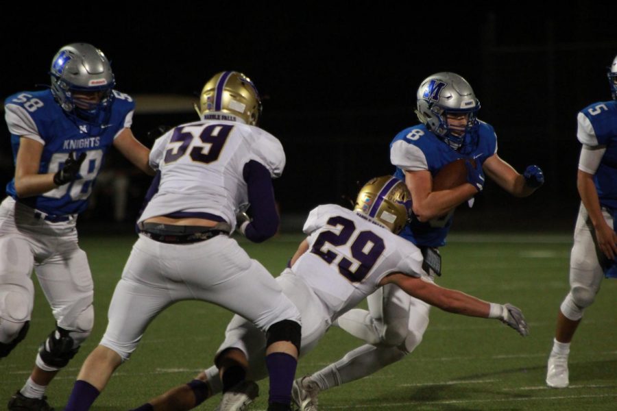 Junior Brock Fanning carries the ball past Mustang defenders during Thursday nights 14-0 victory over Marble Falls at House Park. The Knights had an efficient running game, gaining 151 yards to Marble Falls’ 243. Despite being outgained, the Knights outscored the Mustangs to take home the win.