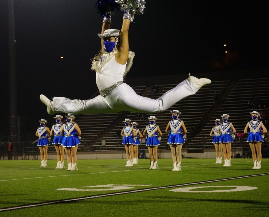 Senior+Blue+Brigade+co-captain+Matthew+Vargas+leaps+during+the+Dec.+11+halftime+show%2C+a+field+pom+dance+to+Edge+of+Glory.+The+game+turned+out+to+be+the+end+of+the+Knights+season%2C+and+the+last+time+the+Blue+Brigade+seniors+would+perform+at+halftime+of+a+high+school+football+game.+%E2%80%9CI+was+really+excited+and+optimistic%2C%E2%80%9D+Vargas+said+of+his+feelings+before+Fridays+game.+%E2%80%9CThe+sunset+was+so+pretty+and+it+just+set+the+mood+and+I+was+happy.%E2%80%9D+By+halftime%2C+the+Knights+trailed+by+21+points+and+the+future+looked+bleak+for+the+season%2C+but+Blue+Brigade+was+still+excited+for+its+performance.+%E2%80%9CI+knew+it+would+be+the+last+performance%2C+so+I+just+wanted+to+give+it+my+all%2C+and+honestly+I+have+never+felt+so+happy+during+a+performance.+Hitting+that+ending+pose+gave+me+the+chills%2C+and+I+had+such+a+big+smile+under+my+mask.%E2%80%9D