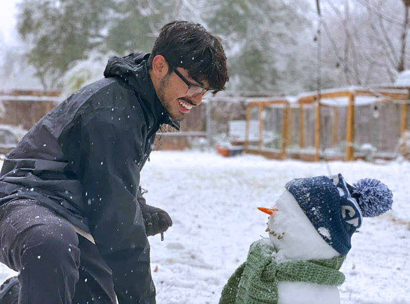 SUNFLOWER SEEDS AND TAMALES: Senior Daniel Dueñas-Lujan inspects his handiwork building a snowman with all the finishing touches. Dueñas said that Sundays snow caught him off guard and that after realizing it was showing he decided to build a snowman, which we have to say looks pretty darn lifelike almost as if Dueñas was meeting Olaf on the set of Frozen. Whats the secret to Dueñas snowman success?  Lots off snow, lots off patience, and just have fun. And, of course, sunflower seeds, which Dueñas used to fashion his snowmans mouth. He said he wasnt outside for long, just long enough to build a snowman and toss a few snowballs in his brothers direction. To warm up after his snow adventure, Dueñas made tamales with his mom and watched football for the rest of the day.