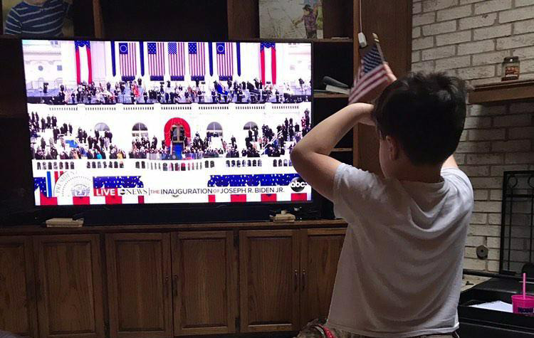 Watching the inauguration from his home on Jan. 20, Alpha Noack, 7, the son of science teacher Sarah Noack, waves his flag and pretends to take the vice presidential oath along with Kamala Harris.