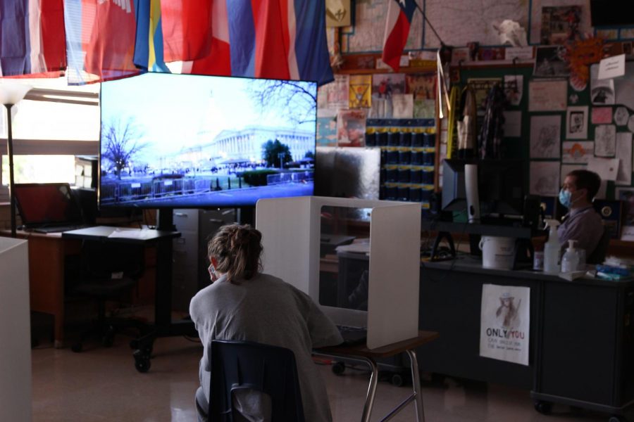 Social studies teacher Greg Anderson and his fourth-period georgraphy student freshman Lucy Minton watch the PBS News Hour coverage of the Capitol insurrection on Jan. 6. 