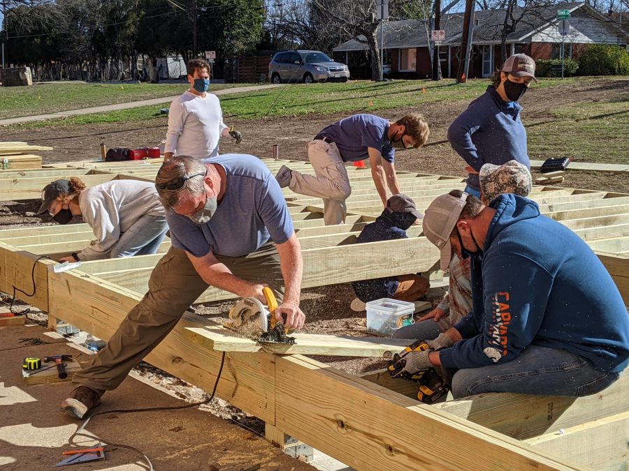 THE FINAL STAGES: The community construction crew the raised a stage this past weekend included faculty members like math teacher Matt Whipple left and interim principal Nicole Griffith (standing at right). Photo by Sarah Noack.