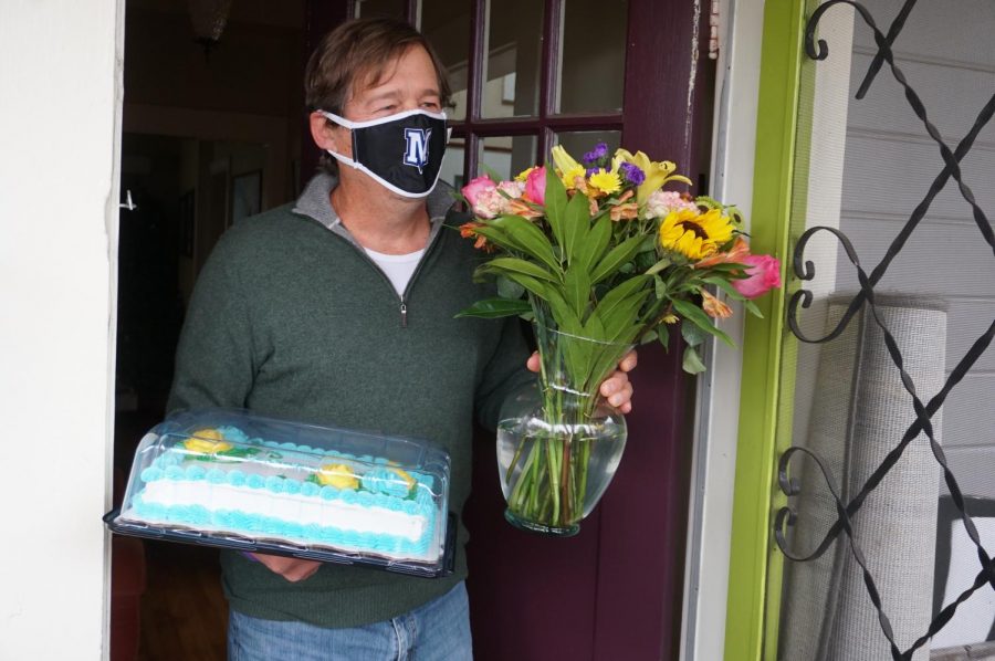 Christopher+Purkiss+accepts+cake+and+flowers+from+principal+Nicole+Griffith+and+assistant+principal+Andy+Baxa+for+being+named+Teacher+of+the+Year.+Purkiss+was+working+with+a+student+over+Zoom+when+they+arrived+at+his+house.+I+thought+Oh%2C+this+is+so+cool%21+I+wanted+to+invite+them+in+to+have+some+coffee+and+chat+until+I+remembered+I+couldnt+invite+anyone+in%2C+Purkiss+said.