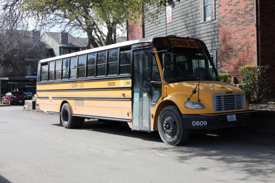 A district-provided Wi-Fi bus parked in front of an apartment complex provides internet access for children living nearby who are attending school virtually. These buses are stationed around Austin every day to ensure that students can access their schoolwork. 