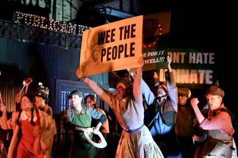 WEE THE PEOPLE: Junior Amethyst Mellberg-Smith holds up a sign during a Urinetown scene involving a protest for the right to “pee for free.” Mellberg-Smith thinks that the show is a commentary on the current political climate. “It’s totally political satire,” Mellberg-Smith said. “It’s making fun of serious situations that are somewhat similar to things happening now, but in such a comedic and absurd way it really shows how messy politics and fighting for what’s right can be.” Mellberg-Smith said that while being on stage for the first time in a year was a rewarding experience, her favorite part of the production was spending time with her friends. “Finally seeing people every day made all of the hard work feel effortless,” Mellberg-Smith said, “and I can’t wait to do it again!” Reporting by Samantha Powers. 