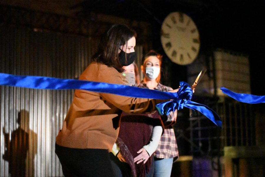 SETTING THE STAGE: Before the opening night of Urinetown: the Musical and with fine arts parents and outdoor stage organizers Nicole Wayman and Shaneye Ferrell looking on in approval, principal Nicole Griffith cuts a ribbon to mark the grand opening of the recently completed outdoor stage. Griffith also took the time to reflect on the process it took to create the stage and recognize the group of community members that worked to make their dream of a safe performance space a reality. District 4 trustee Kristin Ashy also gave a short speech on the drive and commitment of the McCallum community. The outdoor stage, a product of a Lowe’s grant and crowdfunding, is very literally a product of the community working together. A group of over 60 parents, teachers, and student volunteers worked to finish the stage in early February, and the stage will continue to serve as a space for performances, events, and club meetings. Reporting by Bella Russo.