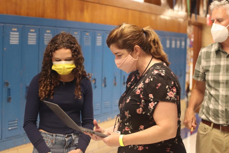 Ms. Crane and Mr. Pass assist a student establish a WiFi connection prior to starting the ninth-grade English STAAR test on Tuesday morning.