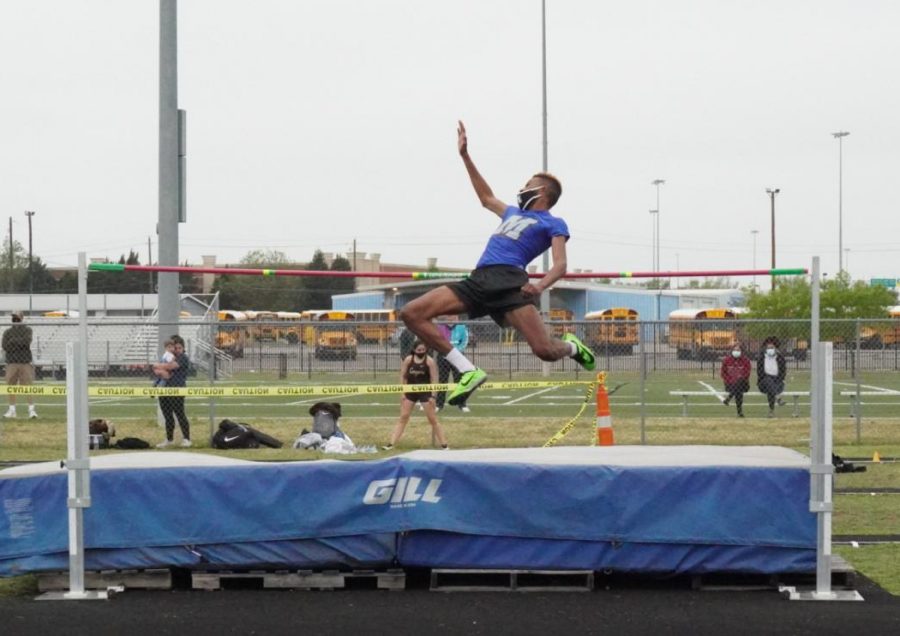 Senior O’Mari Hill leaps over the bar during the high jump early Thursday morning. He secured fourth with a jump of 5 feet, 8 inches, just making the cut for next week’s Regionals meet.
