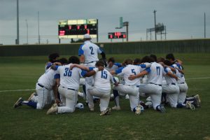 Senior captain Ethan Vandament leads the varsity baseball team as they talk about it before their rivalry game against Anderson on Tuesday April 16. 