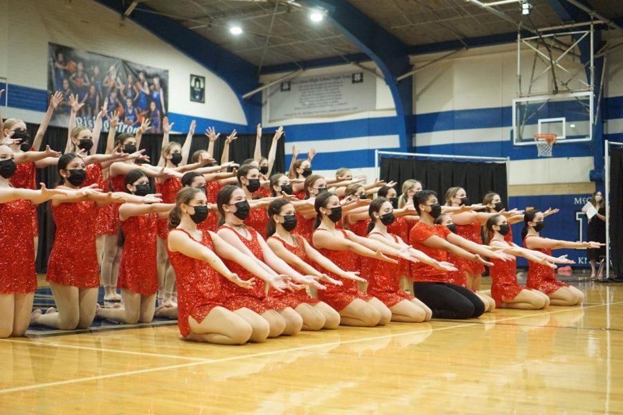 STICKING WITH TRADITION: The McCallum Blue Brigade sticks the final pose during "Last Dance" to conclude their first Spring Show of 2021 on Friday April 16. “My favorite dance is ‘Last Dance’ because it's such a classic!” junior member Natalie Dean said. I think it’s so fun, happy and a great way to end spring show every year,” The routine is full of memories for members past and present as it has been performed at the end of every spring show since 1991. Speaking of traditions, Dean helped to keep another spring show tradition alive when she made a slide show that included photos from the season as well as a tribute to seniors that included current and baby pictures of each graduating dancer.  Reporting by Grace Nugent.