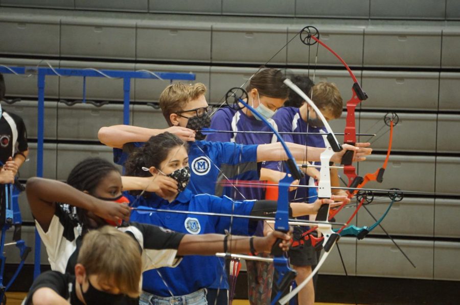 ONE+LAST+TOURNAMENT%3A+With+freshman+teammate+steading+to+shoot+his+arrow%2C+senior+captain+Marianna+Torres+DeLine+releases+her+arrow+during+a+15-meter+round+at+the+2021+National+Archery+in+Schools+Program+National+Archery+Tournament.+The+tournament+was+Torres-DeLines+last+NASP+tournament.%C2%A0+%E2%80%9CThe+fact+that+I+was+able+to+compete+at+that+level+was+insane.%E2%80%9D+After+four+years+of+working+to+get+the+McCallum+archery+program%2C+Torres-DeLine+finished+her+senior+year+competing+in+her+first+national+competition+with+her+team.+In+her+debut+at+nationals%2C+Torres-DeLine+scored+270+points+to+finish+second+among+McCallum+archers.+She+recorded+eight+bullseyes.+Reporting+by+Sophie+Leung-Lieu.