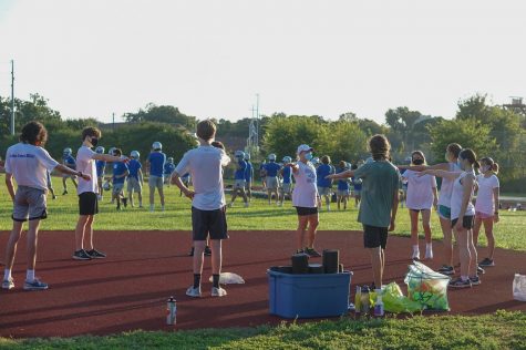 In what turned out to be her last first day of practice as the cross country coach, Susan Ashton huddles up the COVID-safe way with her runners on Sept. 7, 2020.