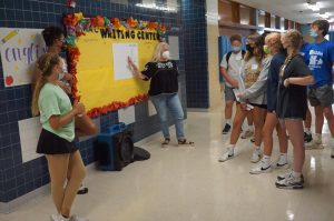 Junior Sophia Kramer and senior Bobby Currie help English teacher Diana Adamson give a tour of the English hall at the freshman orientation. Everyone was masked in compliance with the Austin ISD mask mandate in place.