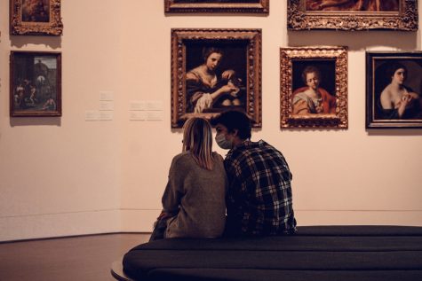 MURMURED CONVERSATIONS: A young couple quietly whisper to each other at the Blanton’s European art gallery, early on a Saturday morning. Because of the reduced visitor in the museum, the typical quiet hum of conversation has dissipated. This turns every conversation or exchange of words instinctively into a whisper. Photo and Caption by Lissa Castro.