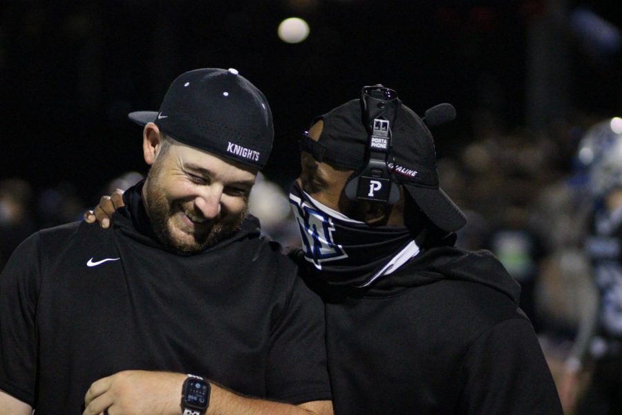 DEFENSIVE DELIGHT. Coach Grant and Coach Houston bond over the team’s shared victory at the 2021 Taco Shack Bowl. As the only two paid defense coaches on staff during the game, both Grant, Houston, and the team were under great stress. Yet despite this setback, the team managed to pull through and secure the win for McCallum. “I think that was just a lot of pure emotion and joy coming to a head because it was a tough week,” Grant said about the moment. “Defensive on a two-coach staff is incredibly difficult. And I think it was not disbelief, but it was the first time we could take aside to be proud of what the kids just accomplished.” Reporting by Evie Bernard. Photo by Evie Bernard. 