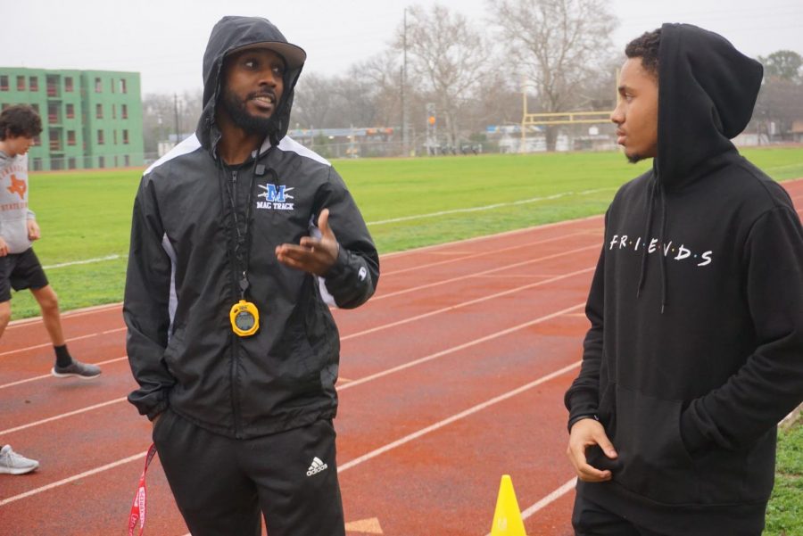 Head boys track coach Jarred Houston talks with then sophomore Jonathan Porter at the teams practice before school on Jan. 21, 2020. In his three years as head coach, Houston has helped to build the track program up. He agrees with the athletes that a class would help that program take another step forward competitively. 