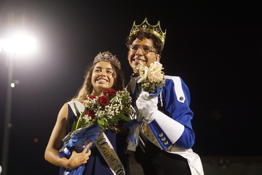 GOMEZ AND CURRIE TAKE THE CROWNS: Senior homecoming royals Mia Gomez and Bobby Currie smile for the crowd after the announcement of their victory. For Currie, a three-time homecoming royalty member, this was an extremely memorable moment. “I hadn’t really put that much thought into the fact that I was a finalist; I just kind of went through the motions,” Currie said. “So when I heard my name called and then all the cheering, cameras and seeing the crown, my mind was just in shock and I was overwhelmed with excitement.” Having Gomez by his side was also special for Currie. “I love the diversity between the two of us. I think it represents McCallum very well,” he said. “I first met Mia in freshman year world geography, so this was kind of a cool full circle moment for us.” As seen in his marching band attire, Currie participates in many extracurriculars at McCallum — making this moment that much more appreciated. “I try to get very involved around here, so it was cool getting validation from the people I love very dearly,” Currie said. “It is definitely something I will always remember for the rest of my life.” Reporting by Madelynn Niles. 