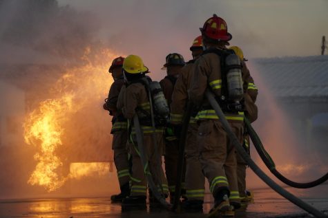 Senior members of the LBJ Fire Academy line up to put out the propane fire at their first live fire skill day of the school year. Each person in the line has a specialized job, first in line holds the nozzle of the hose, the second and third are backup and the fourth person is the hose wrangler, making sure they have enough hose left to turn. “We just had to learn every single job, and that was stressful,” senior and LBJ Fire Academy member Michael Valentino said. “Every person has their job and they have to do it, and if you don’t do it it’s gonna go bad.” Caption by Kennedy Weatherby. 