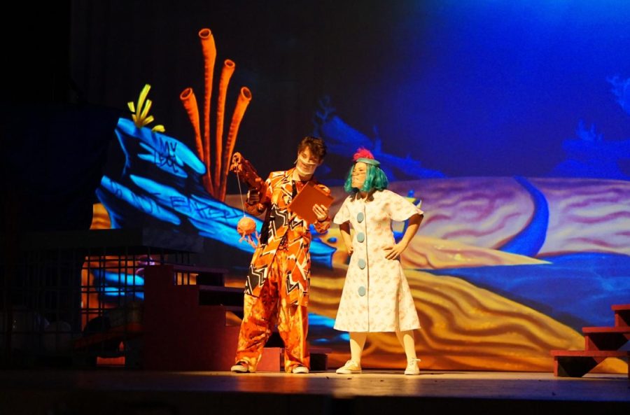 The SpongeBob Musical cast members Finn Higginbotham (Larry the Lobster) and Alice Scott (the mayor of Bikini Bottom) perform a scene together. Higginbotham had to assume the role of Larry the Lobster after Salem McFadden sprained their ankle on opening night.