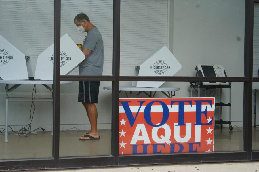 A voter fills out his ballot in the McCallum Arts Center polling location this morning during FIT. Traffic was pretty light at the location all morning.