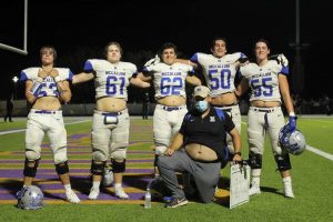 The Mac offensive line, seniors Borman, Bednar, Price, Butler and Holmes, and their coach, Brad Bernard, put the b in belly while posing for a photo at Marble Falls, the site of one the Knights signature wins this season. 