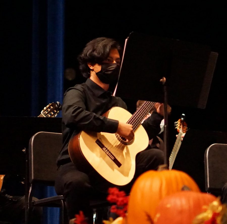Senior Juan Itzep plays as a part of the McCallum Classical Guitar Chamber Ensemble at the annual guitar and orchestra fall concert in the MAC on Oct. 20. Itzep, one of the two first chair members of the group, acts as a leader and example for other guitar students. He sits in the front of the ensemble and often performs solo moments in pieces.
