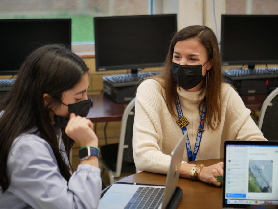 Camille Nix helps senior Frances Arellano fill out a scholarship application.