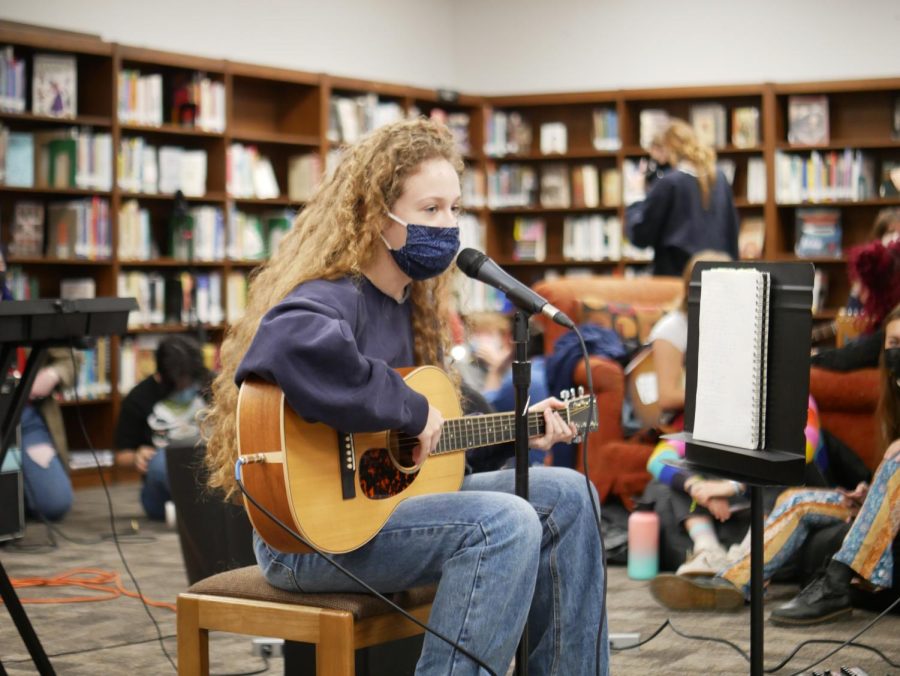 Junior Charlotte Blackmon performs a song she wrote for Coffeehouse. “I hadn’t played it for anyone yet, but I felt that it was ready to perform,” Blackmon said. “Luckily, it was well-received.” Her favorite part of the event was sitting with the other performers. “Everyone was super positive and hyper each other up, the energy of it felt really great.” Caption by Evie Barnard.